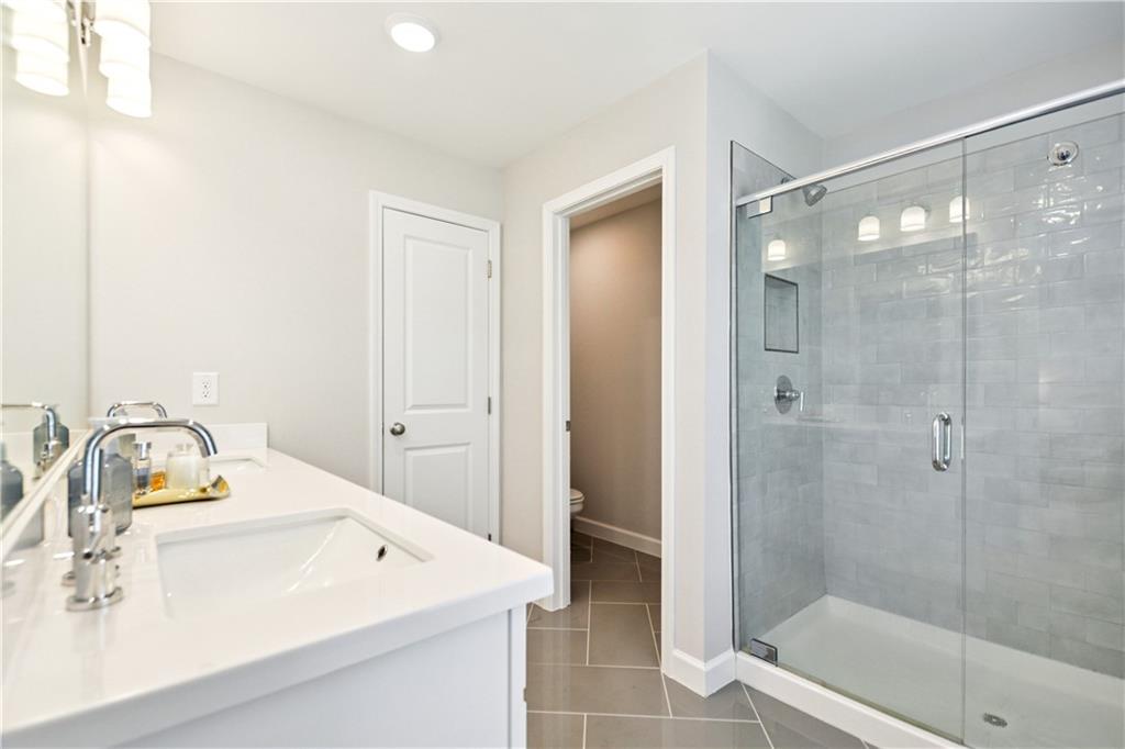 765 Trevett Way Marietta, GA 30066 - Photo 21 of 44 a bathroom with a sink mirror and shower