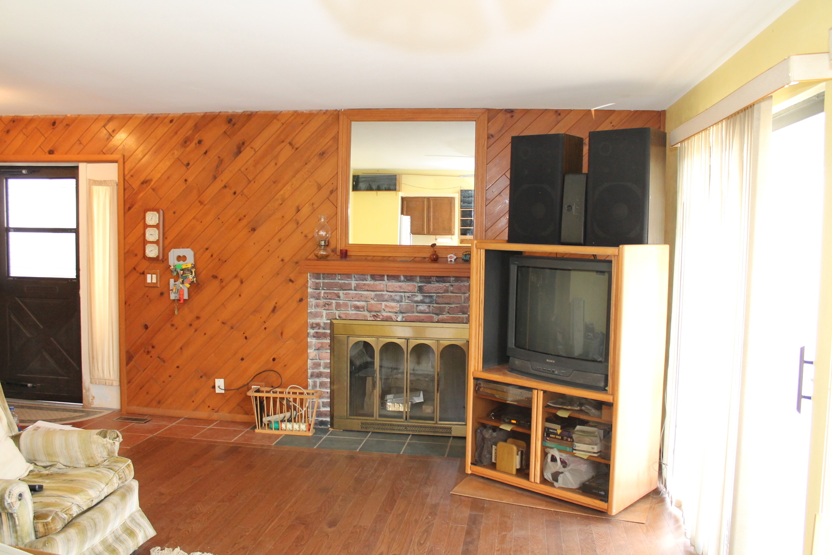 69 White Oaks Road, Unit 69 Fox Lake, IL 60020 - Photo 3 of 16 a living room with a fireplace furniture and a flat screen tv