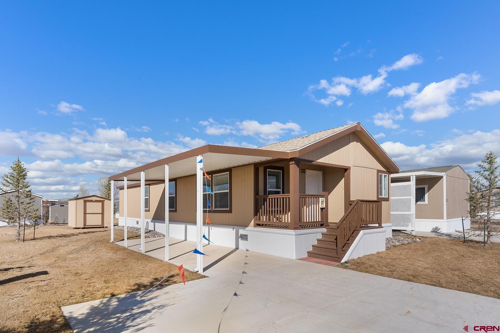 901 6530 Road, Unit 2836 Montrose, CO 81401 - Photo 1 of 21 a front view of a house with a garden