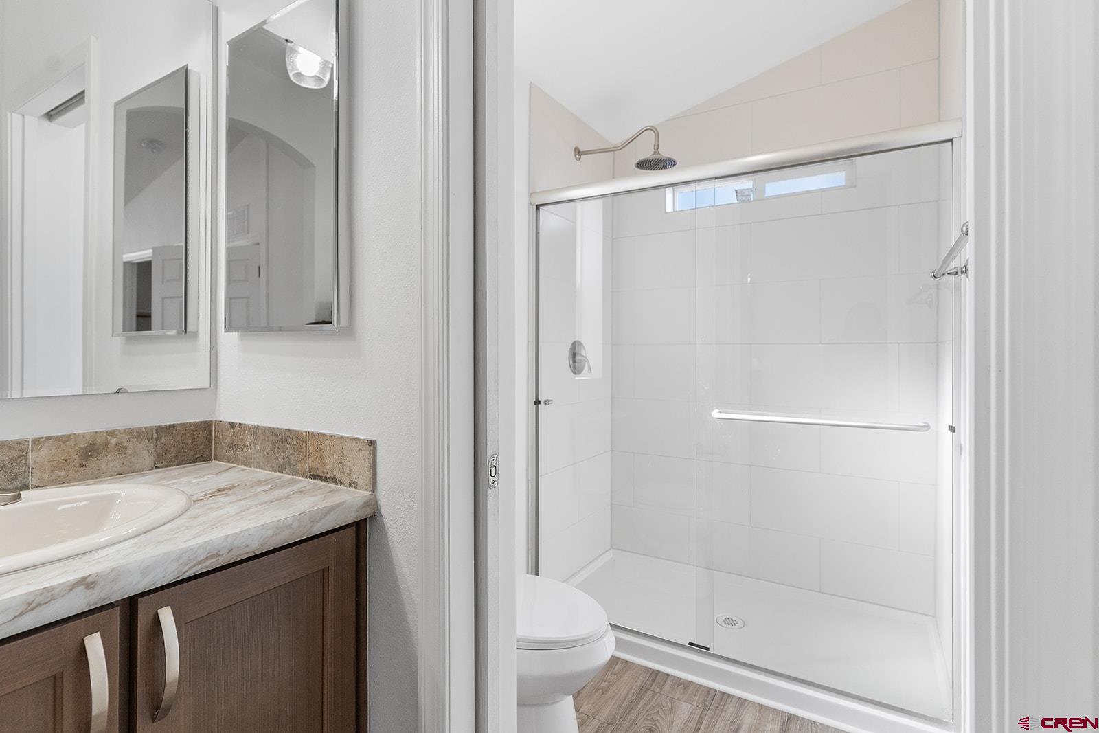 901 6530 Road, Unit 2836 Montrose, CO 81401 - Photo 13 of 21 a bathroom with a granite countertop shower mirror and toilet