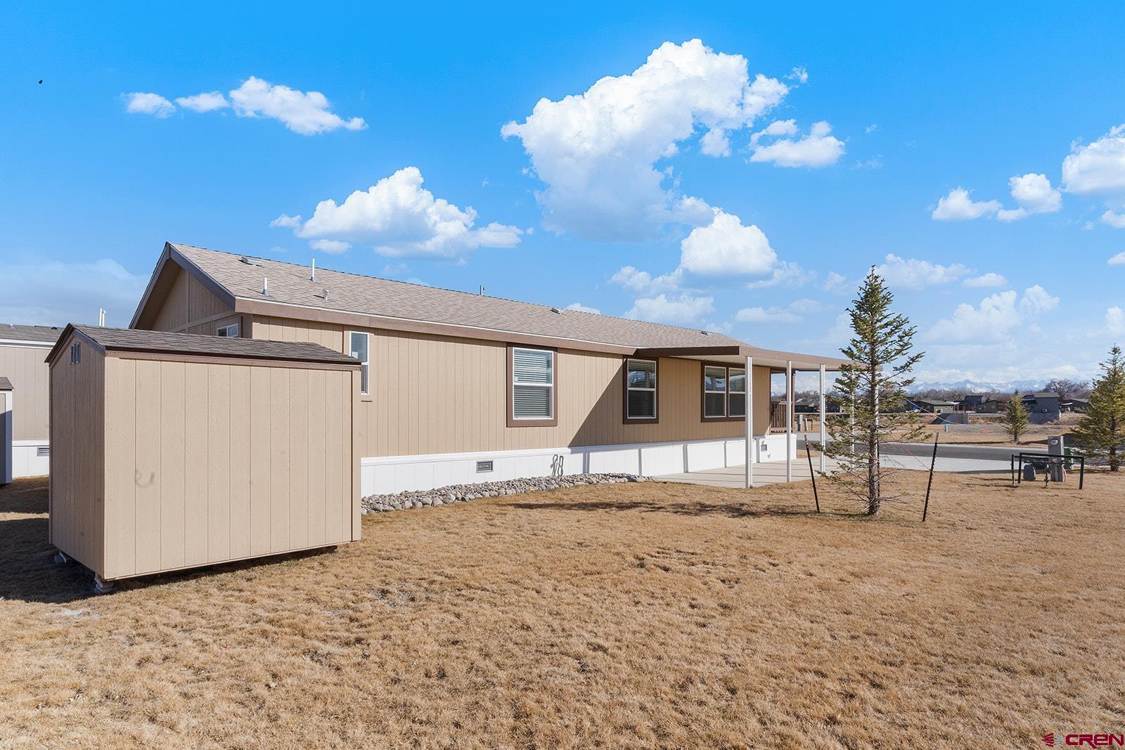 901 6530 Road, Unit 2836 Montrose, CO 81401 - Photo 3 of 21 a view of a house with a backyard