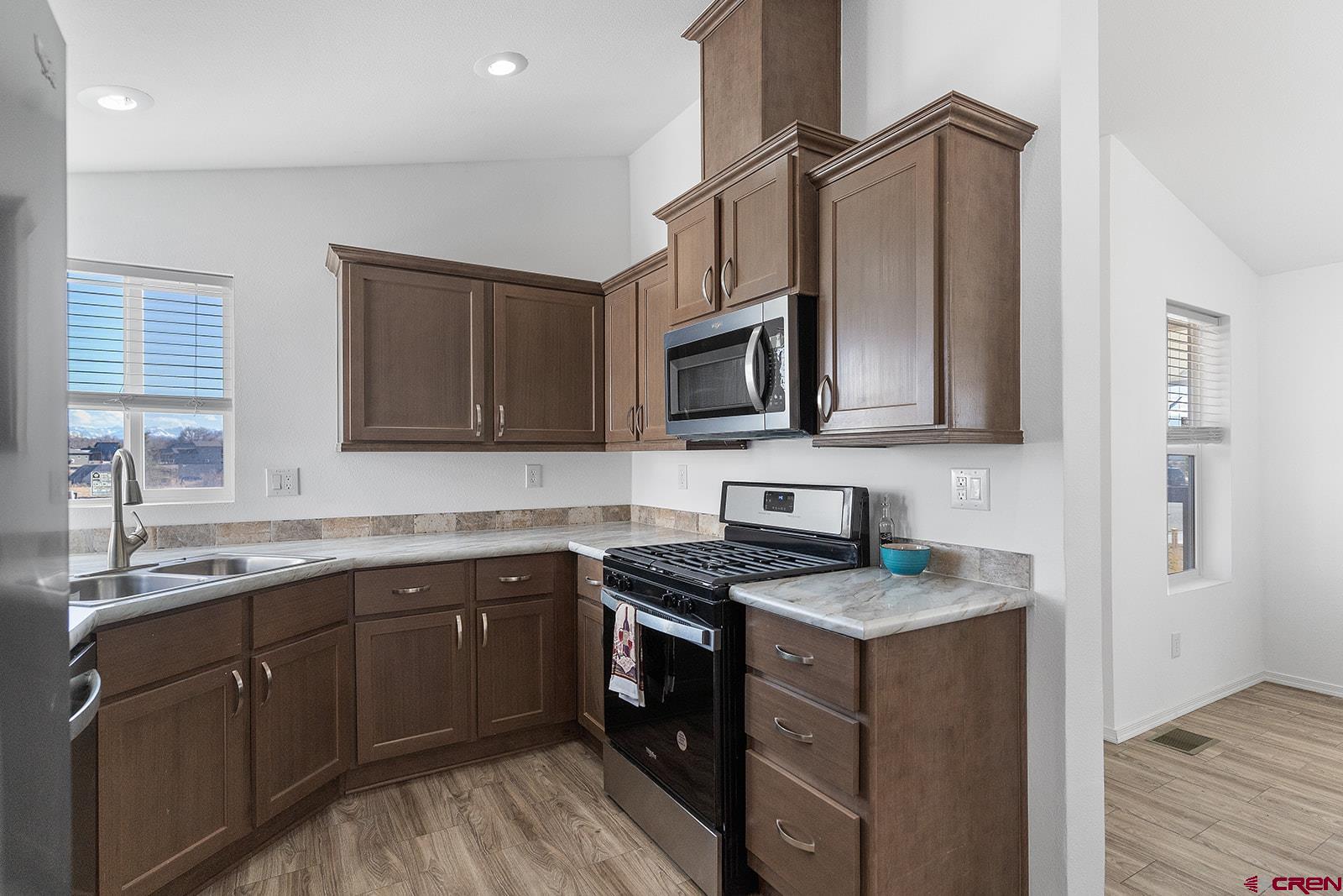 901 6530 Road, Unit 2836 Montrose, CO 81401 - Photo 7 of 21 a kitchen with stainless steel appliances granite countertop a sink stove and microwave