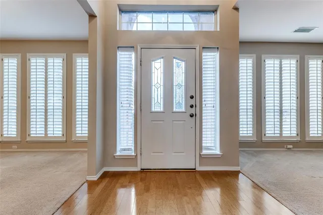 wooden floor in an empty room with a window