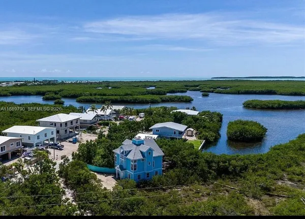 an aerial view of a house with outdoor space