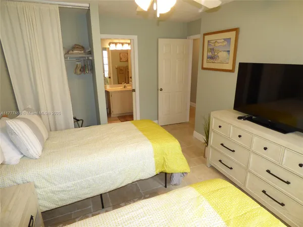 a bedroom with a bed and flat screen tv