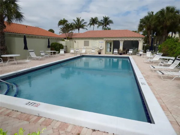 a swimming pool view with a outdoor seating