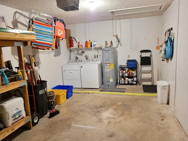 a utility room with cabinets dryer and washer