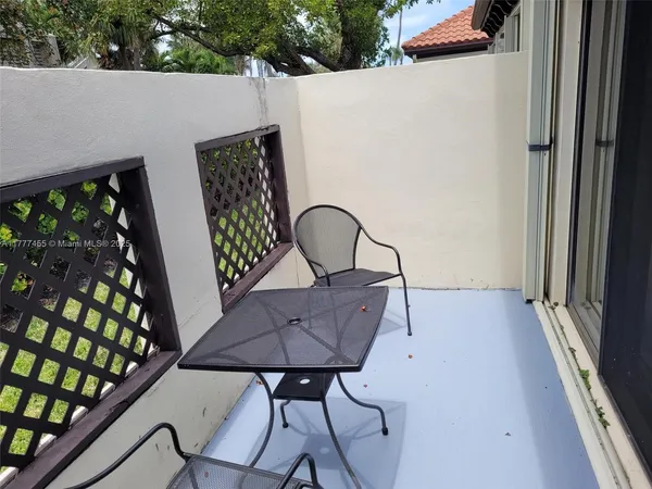 a view of a couches and table in the balcony