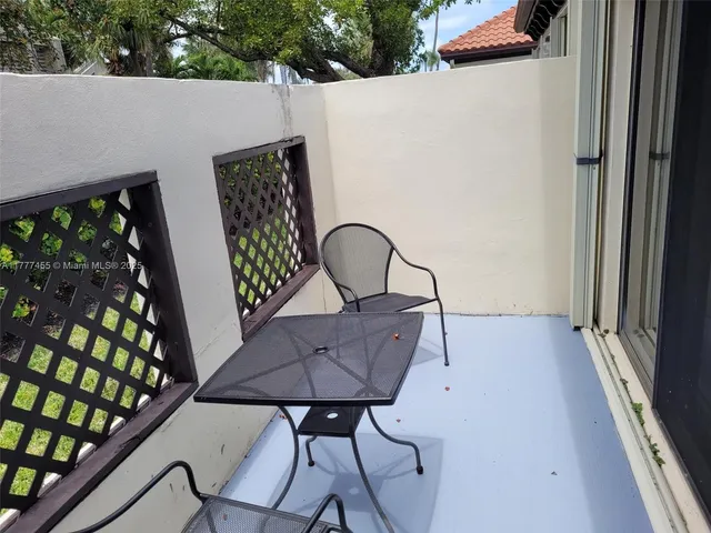 a view of a couches and table in the balcony