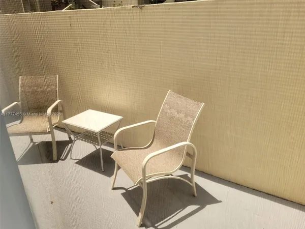 a view of a room with table and chairs