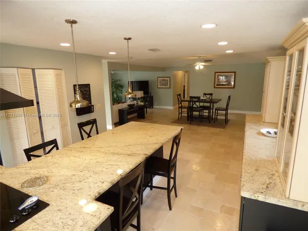 a large kitchen with a table and chairs