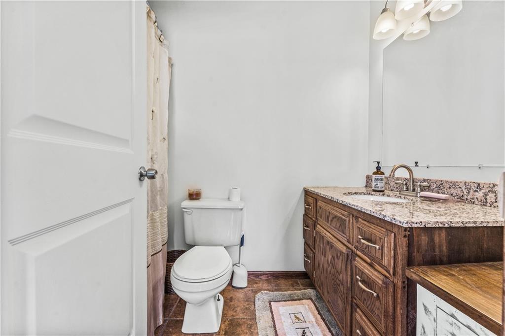 259 Line Road Mercer, PA 16137 - Photo 23 of 33 a bathroom with a granite countertop toilet sink and mirror