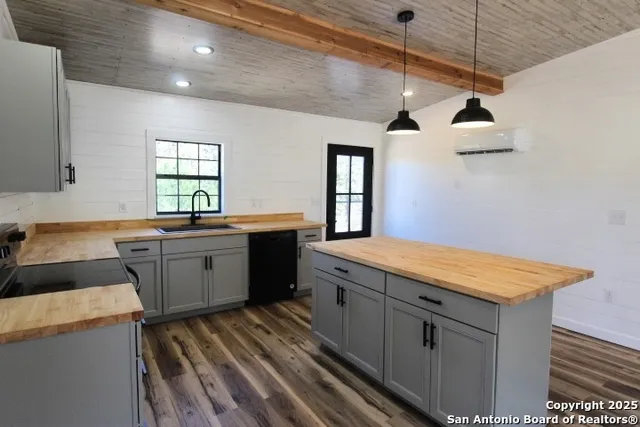 a kitchen that has a sink and a stove in it