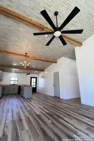 a view of a room with wooden floor