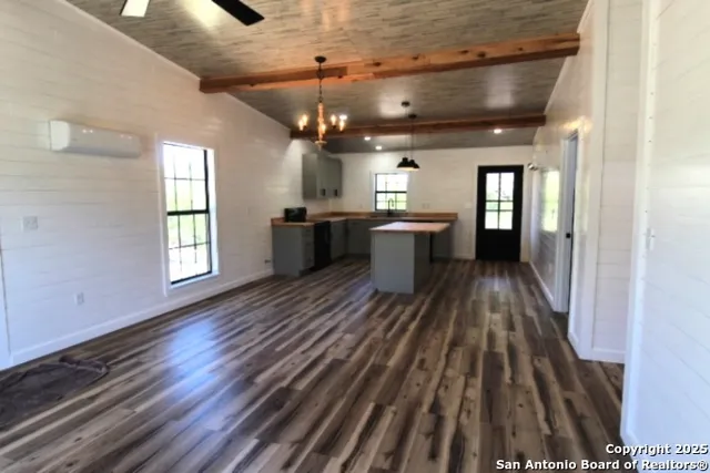a view of a room with wooden floor