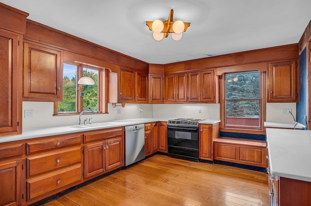 65 Bailey Road Andover, MA 01810 - Photo 7 of 42 a kitchen with stainless steel appliances granite countertop a stove a sink and a microwave