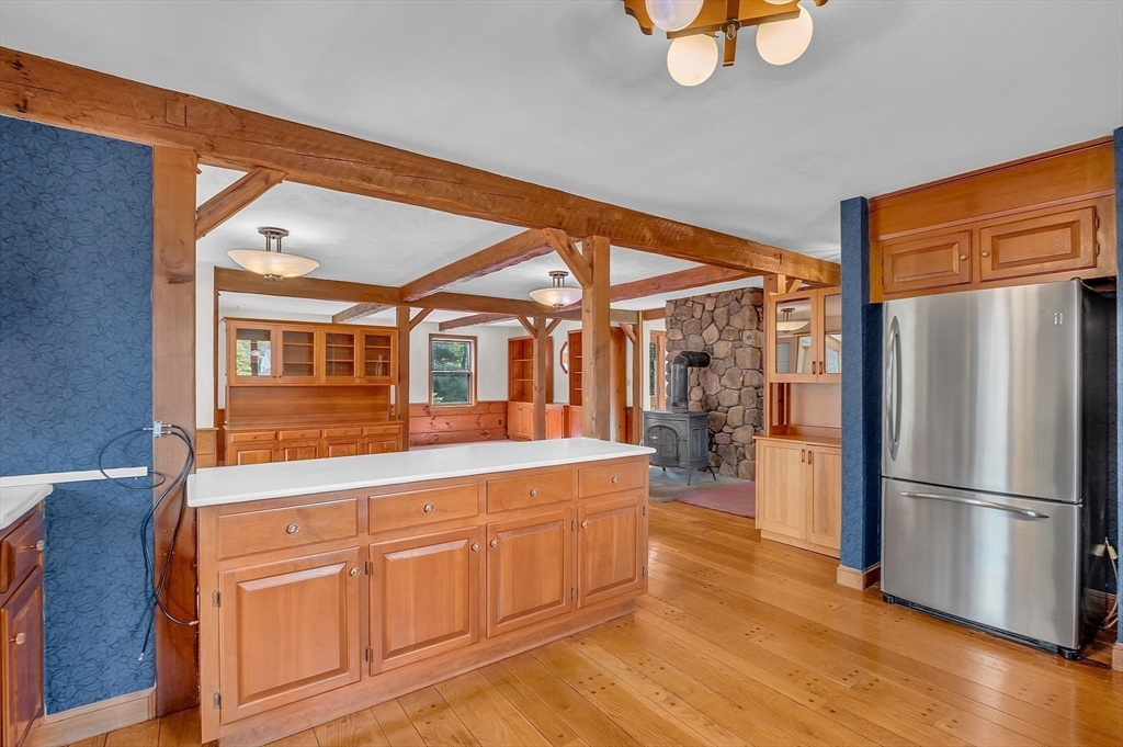65 Bailey Road Andover, MA 01810 - Photo 8 of 42 a kitchen with stainless steel appliances granite countertop a refrigerator a oven and white cabinets with wooden floors