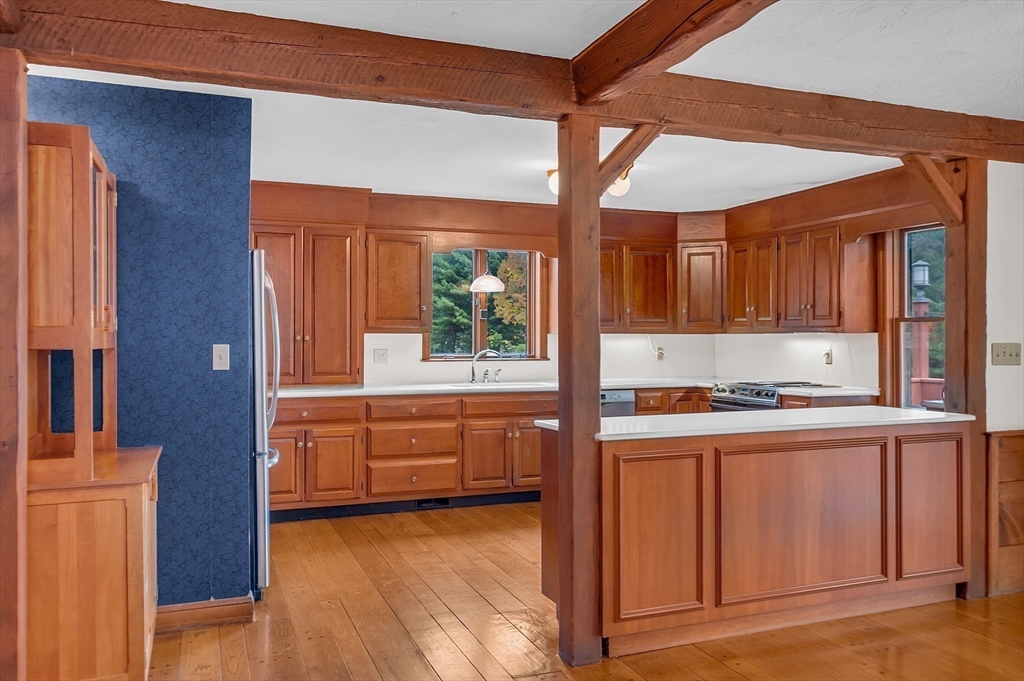 65 Bailey Road Andover, MA 01810 - Photo 10 of 42 a kitchen with stainless steel appliances granite countertop a stove and a refrigerator