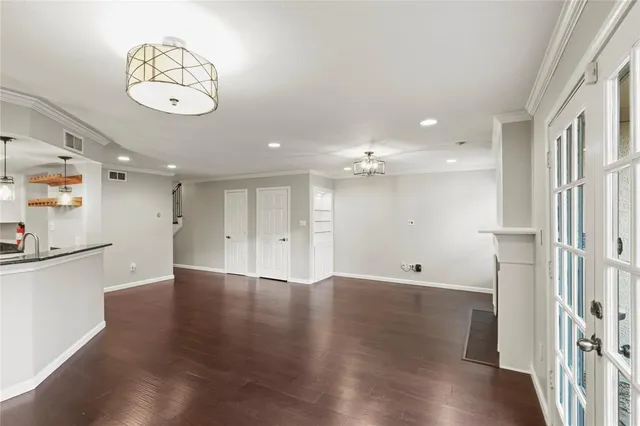 an empty room with wooden floor and a large window