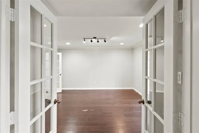 a view of a hallway with wooden floor and staircase