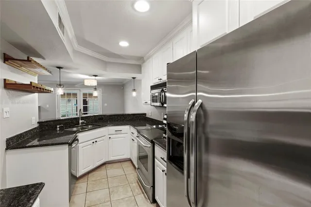 a bathroom with a granite countertop sink vanity mirror and toilet