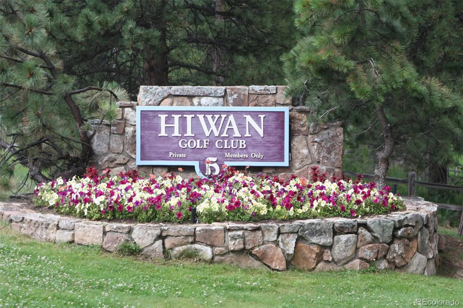 Mountain Park Road Evergreen, CO 80439 - Photo 24 of 50 a view of sign board with yard and flowers