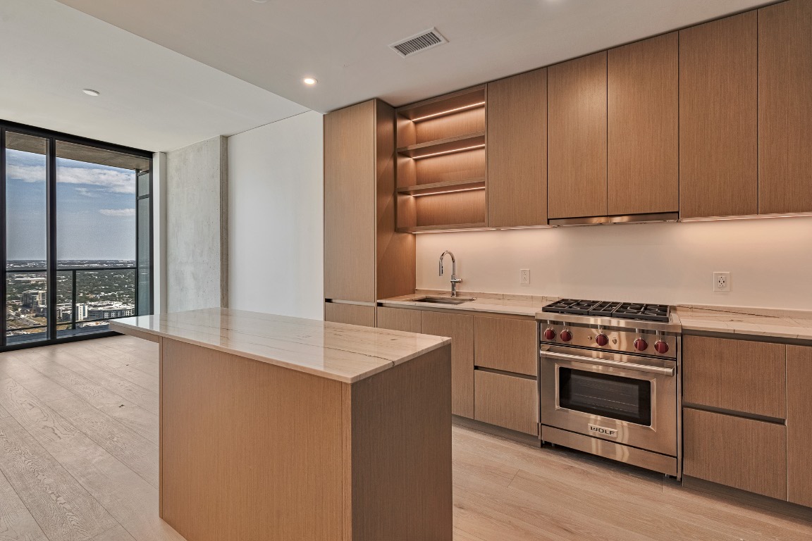 610 Davis Street, Unit 4406 Austin, TX 78701 - Photo 1 of 36 a kitchen with a stove and a sink