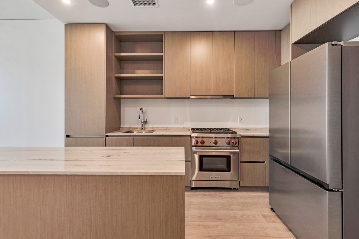 a kitchen with a refrigerator and a stove
