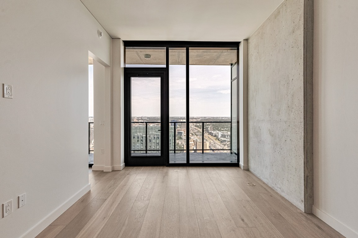 610 Davis Street, Unit 4406 Austin, TX 78701 - Photo 11 of 36 wooden floor and windows in an empty room