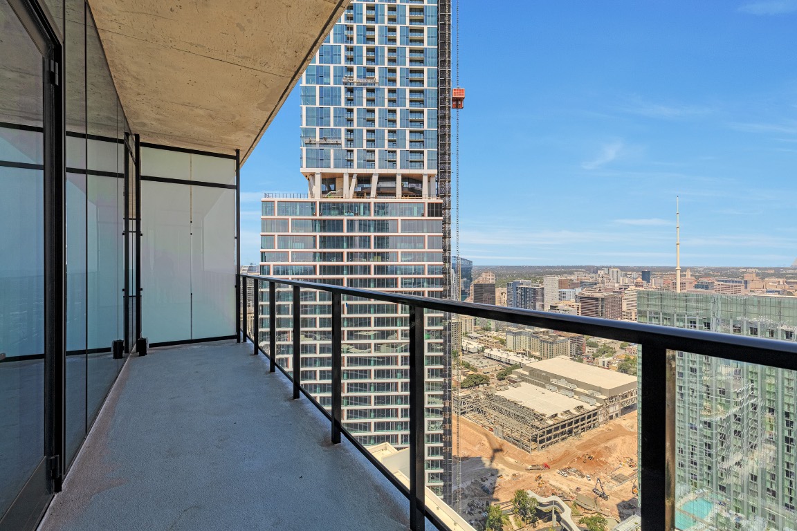 610 Davis Street, Unit 4406 Austin, TX 78701 - Photo 17 of 36 a view of a balcony with wooden floor and fence