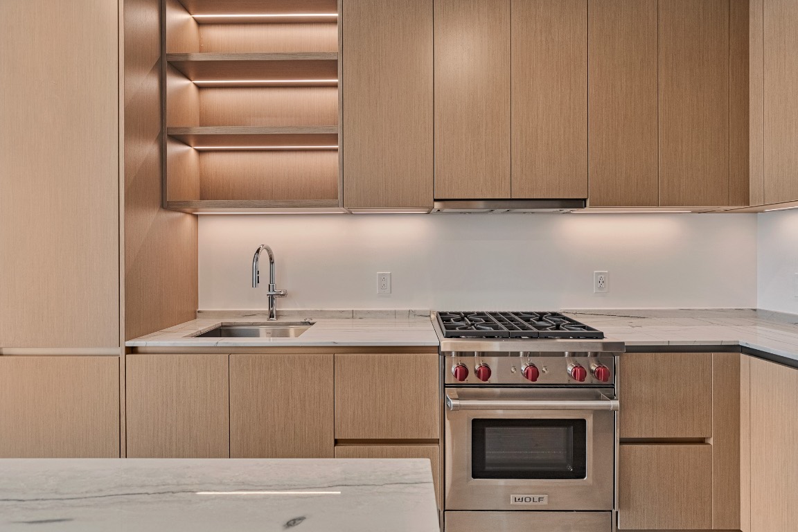 610 Davis Street, Unit 4406 Austin, TX 78701 - Photo 2 of 36 a kitchen with granite countertop a stove and a sink