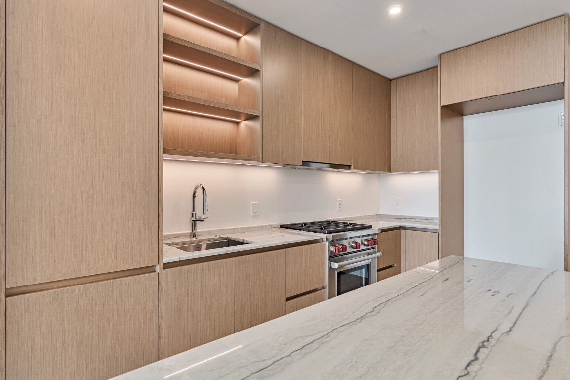 610 Davis Street, Unit 4406 Austin, TX 78701 - Photo 3 of 36 a kitchen with a stove and a refrigerator