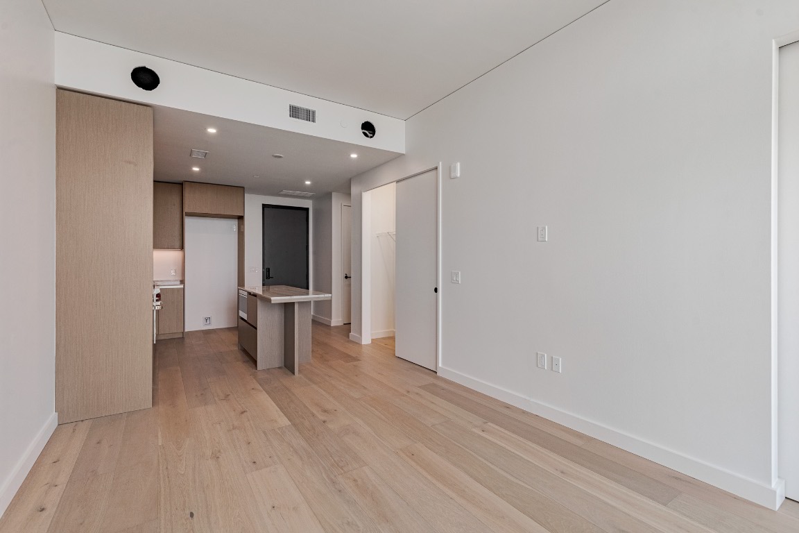 610 Davis Street, Unit 4406 Austin, TX 78701 - Photo 7 of 36 wooden floor in an empty room with a window