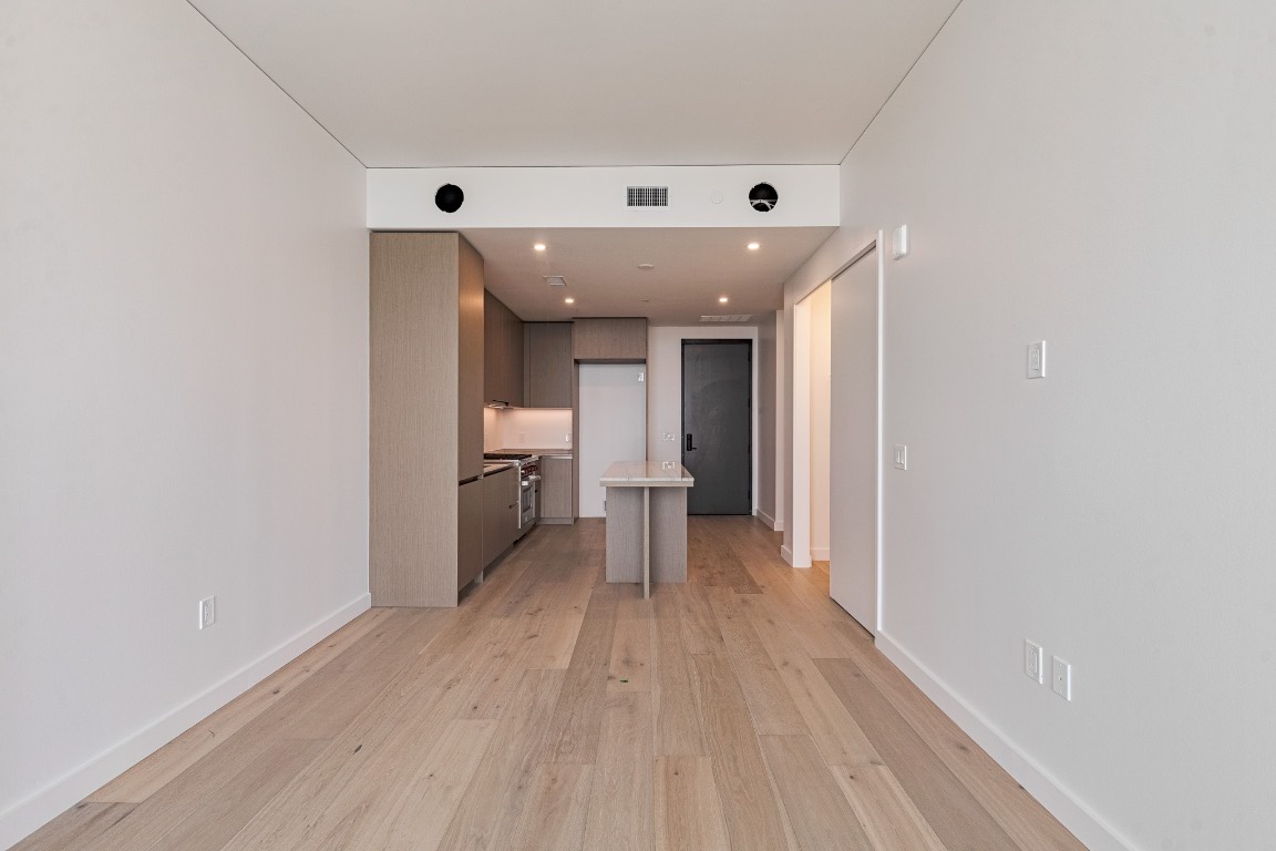 610 Davis Street, Unit 4406 Austin, TX 78701 - Photo 9 of 36 a view of a hallway with wooden floor