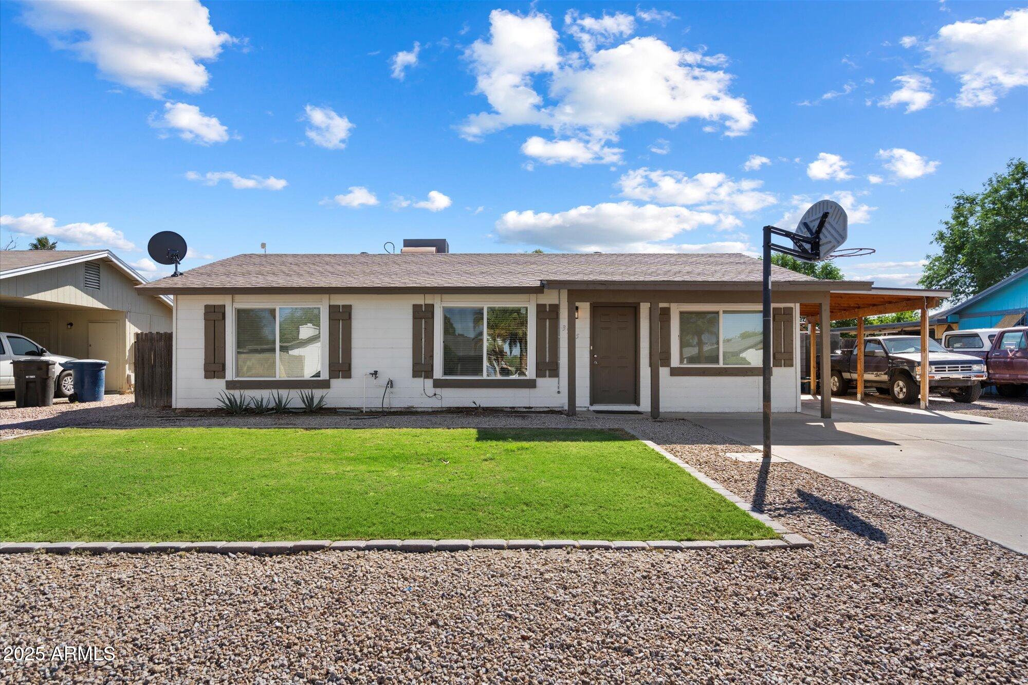 a view of a house with a backyard