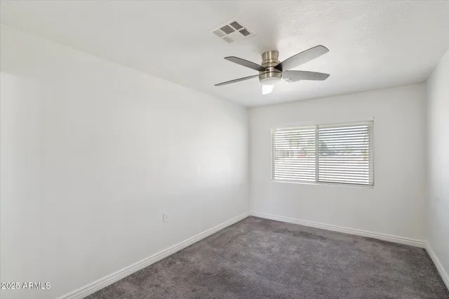 a view of empty room with closet and window