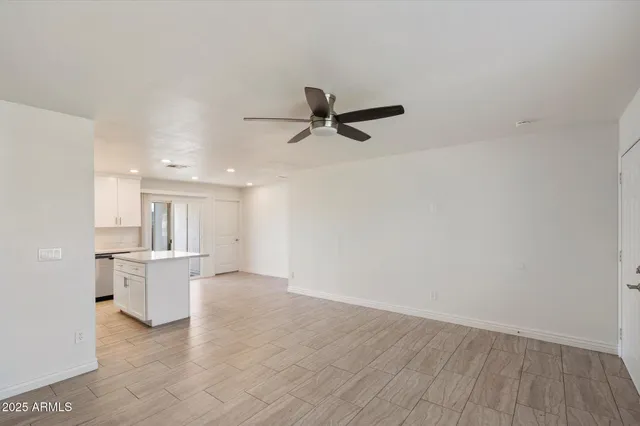 a view of a kitchen with a sink and wooden floor