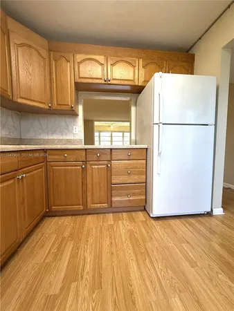 a view of a kitchen with wooden floor