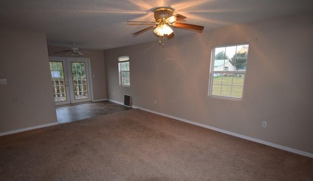 1508 McCauley Road Baker, FL 32531 - Photo 3 of 12 an empty room with windows and fan