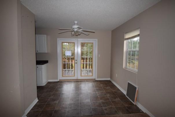 1508 McCauley Road Baker, FL 32531 - Photo 6 of 12 a view of an empty room with wooden floor and a window