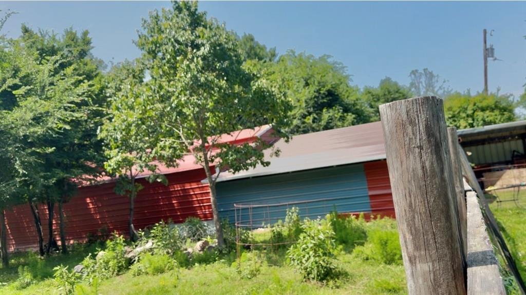 8261 County Road 381 Tyler, TX 75708 - Photo 20 of 40 a view of a wooden house with a small yard and potted plants