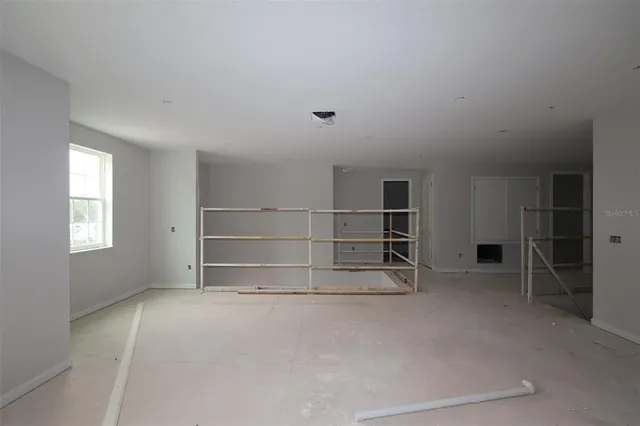 a view of an empty room with a fireplace