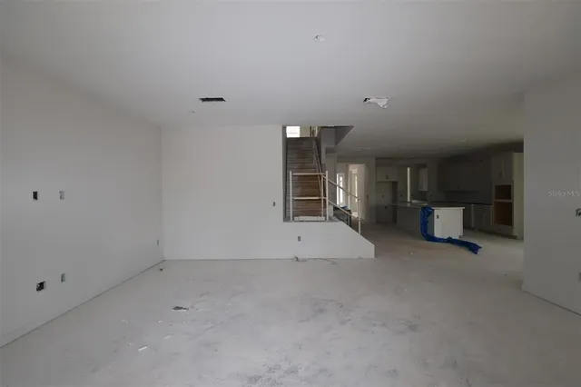 a view of empty room with closet and cabinet