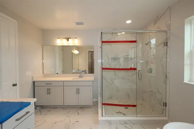a bathroom with a double vanity sink and mirror