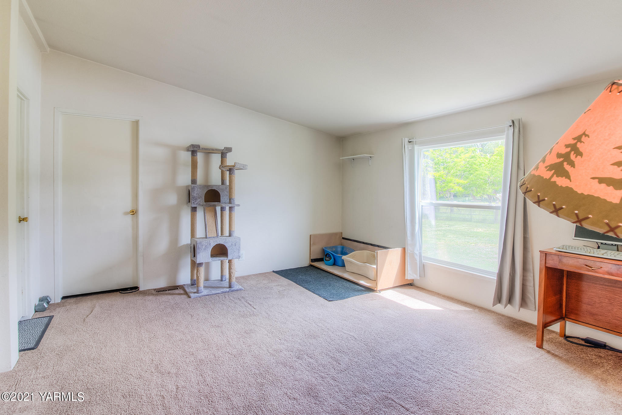 10204 Meadowbrook Road Yakima, WA 98903 - Photo 7 of 29 a view of an empty room with a fireplace and a window
