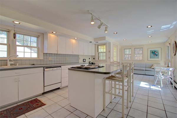 110 Belknap Road Framingham, MA 01701 - Photo 12 of 30 a kitchen with cabinets and chairs