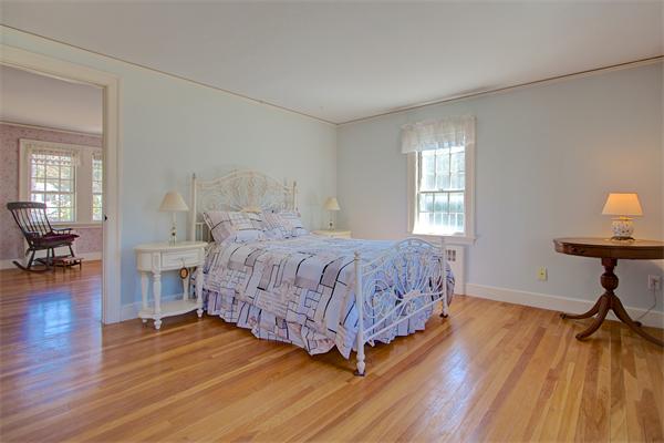 110 Belknap Road Framingham, MA 01701 - Photo 19 of 30 a bedroom with a bed and wooden floor