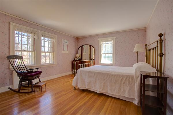 110 Belknap Road Framingham, MA 01701 - Photo 20 of 30 a bedroom with a bed and wooden floor