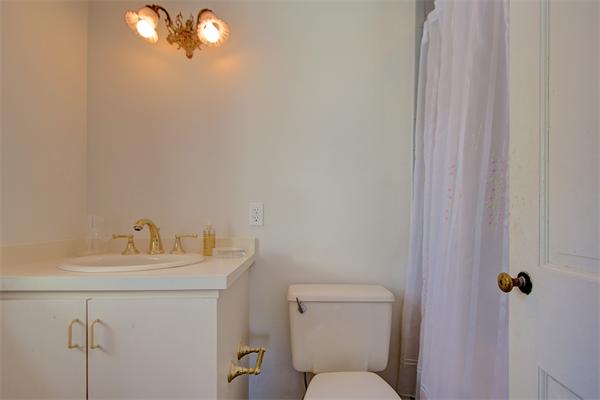 110 Belknap Road Framingham, MA 01701 - Photo 25 of 30 a bathroom with a toilet sink vanity and mirror