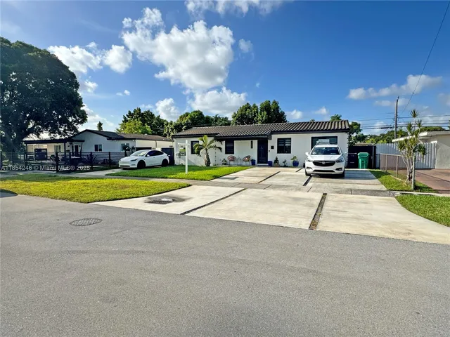 a view of a house with swimming pool and sitting area